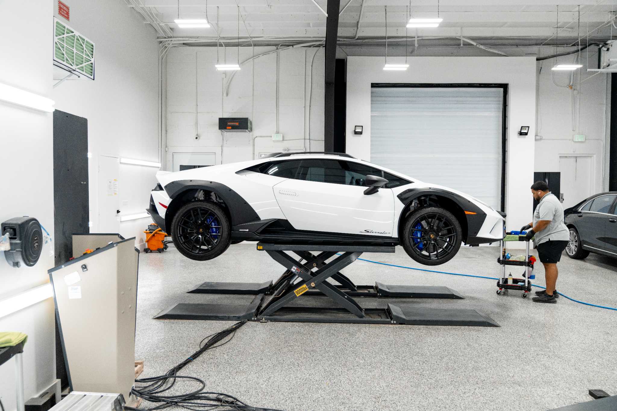Detailers of Fort Myers facility with a supercar in the install bay