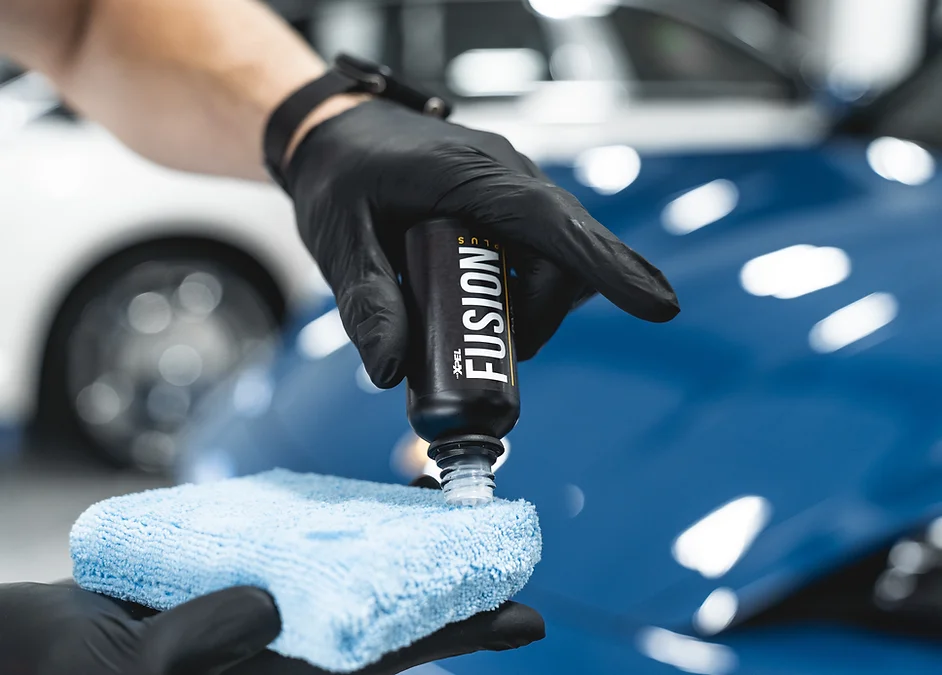 Installer applying ceramic coating to a blue car
